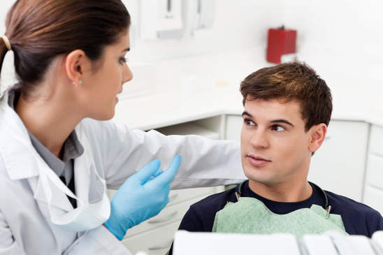 dentist speaks with dental patient