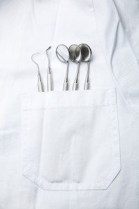 what does a dentist use? close up of dental tools in a dentist's pocket